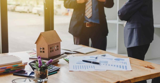 Two men standing in the background of an estate plan