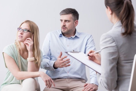 A couple arguing during marriage counseling.
