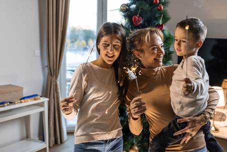 mother and children playing with sparklers