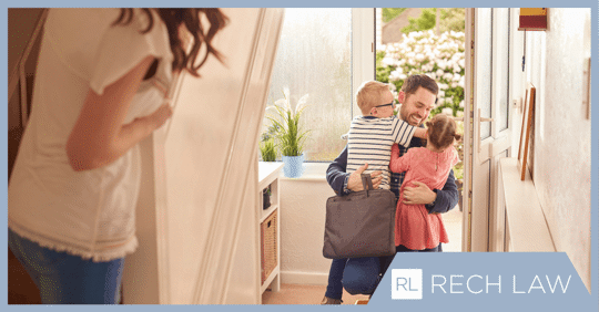 children hugging dad while mom watches