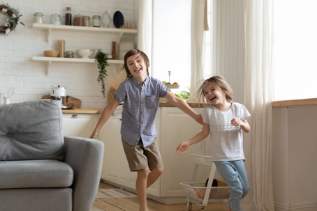 Two children playing inside a home.