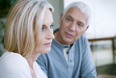 A gray-haired man and a blonde woman sitting next to each other.