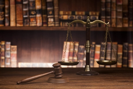 law theme, mallet of the judge, justice scale, books, wooden desk