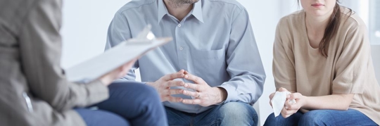 Conflicted husband and wife during divorce mediation with psychologist