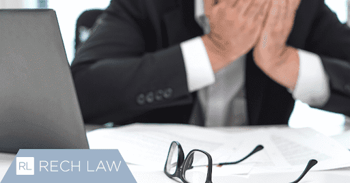 stressed man with hands in face